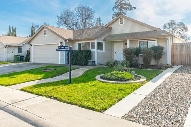 a view of a house with a yard patio and a swimming pool