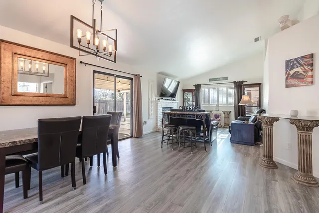 a living room with furniture dining table and wooden floor