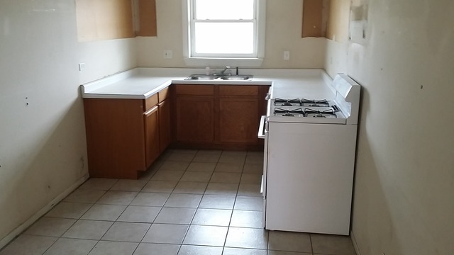 14547 Keystone Avenue, Unit 4 Midlothian, IL 60445 - Photo 3 of 8 a kitchen with a cabinets and a stove top oven