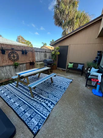 a roof deck with table and chairs