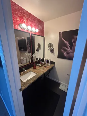 a bathroom with a sink a mirror and vanity