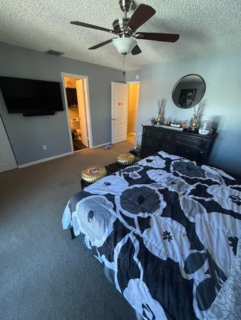 a bedroom with a bed and a chandelier