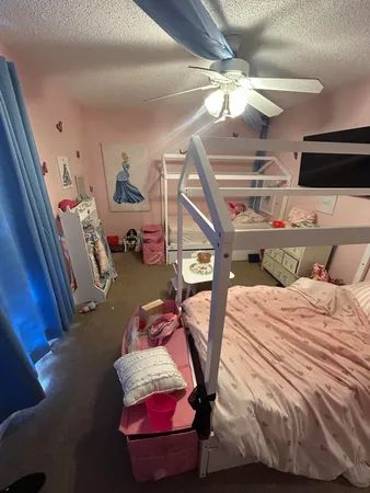 a bedroom with a bed and a chandelier