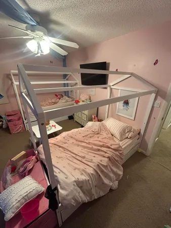 a bedroom with a bed and a chandelier