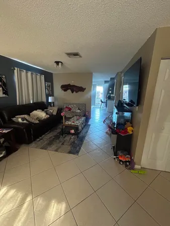 a living room with furniture gym equipment and a window