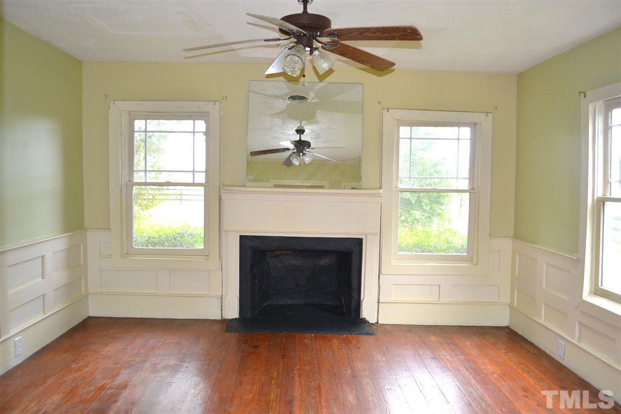 10769 Beaver Dam Road Middlesex, NC 27557 - Photo 12 of 14 a living room with a fireplace ceiling fan and wooden floor