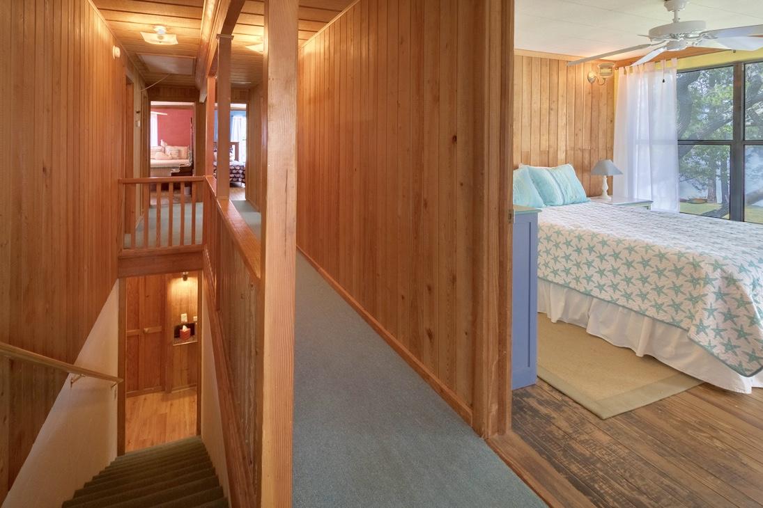 79 Garfield Street Santa Rosa Beach, FL 32459 - Photo 24 of 49 a bedroom with a bed and a chandelier