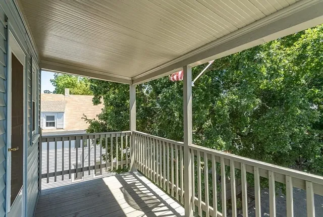 a view of a balcony with wooden floor