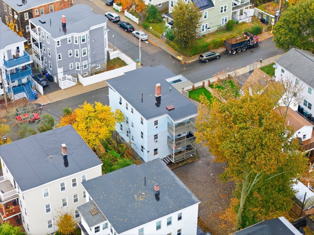 124 Selden Street Boston, MA 02124 - Photo 2 of 35 an aerial view of residential houses with outdoor space and parking