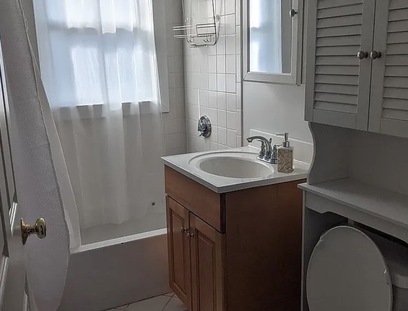 124 Selden Street Boston, MA 02124 - Photo 30 of 35 a bathroom with a sink and a mirror