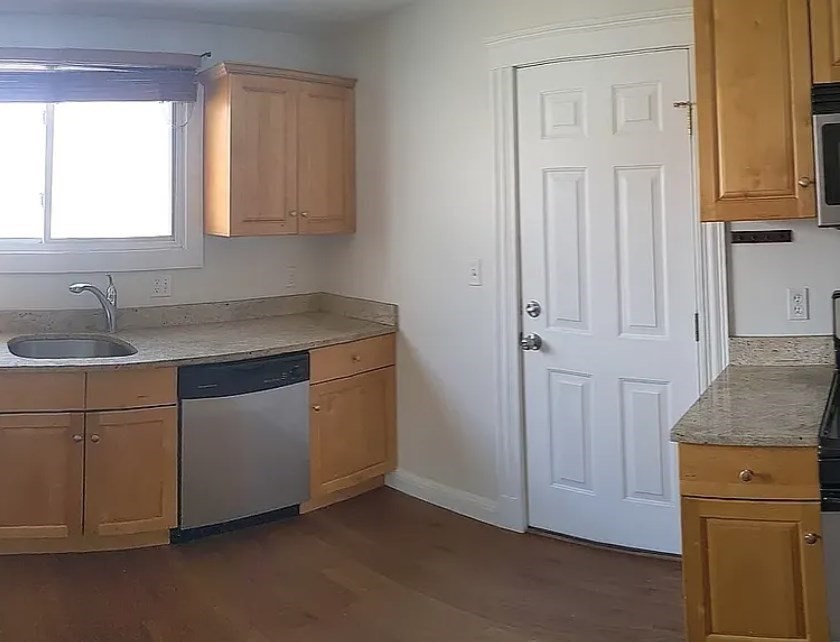 124 Selden Street Boston, MA 02124 - Photo 31 of 35 a kitchen with granite countertop white cabinets and sink
