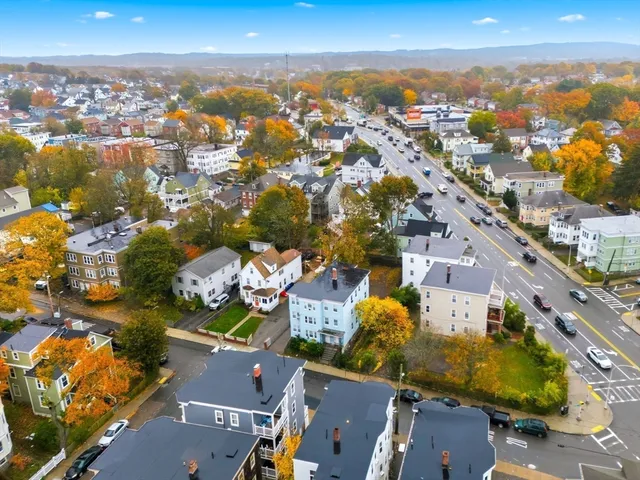 an aerial view of residential building with parking