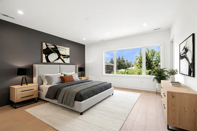 a bedroom with a large bed and a large window