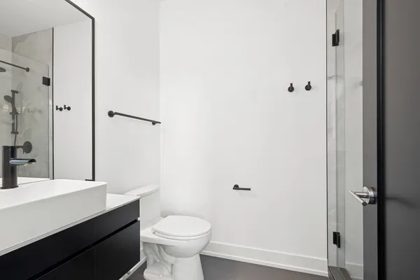 a bathroom with a sink a toilet a shower and a mirror