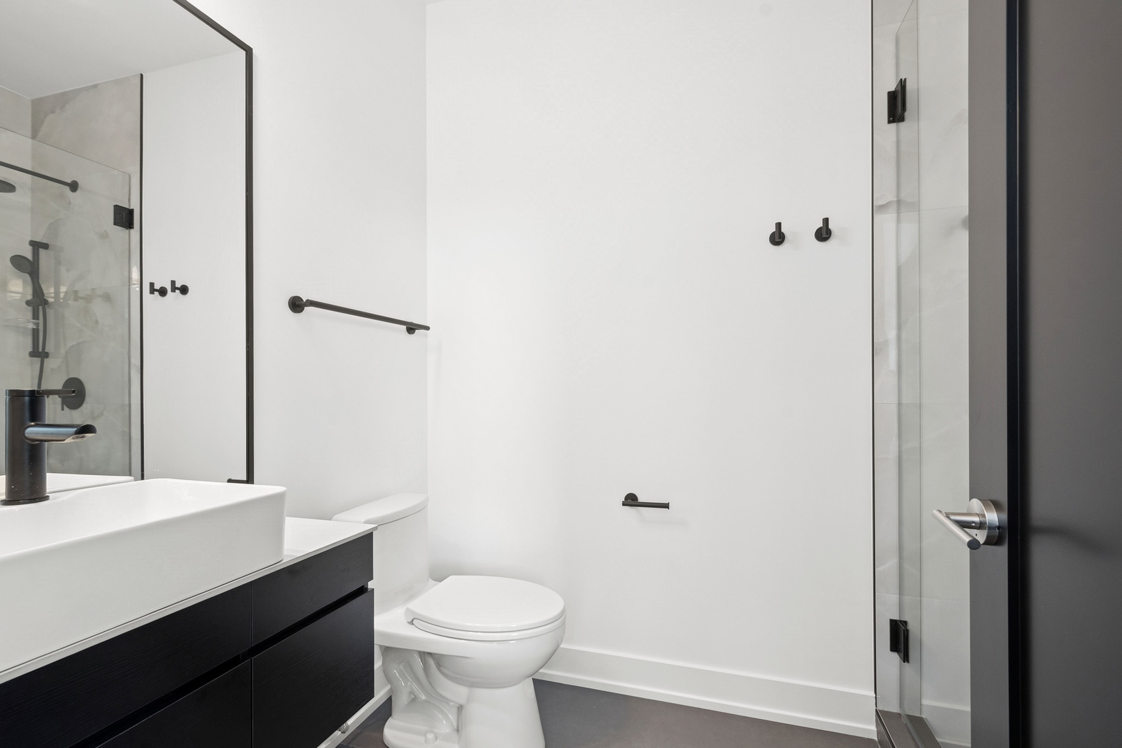 9214 Washington Street Niles, IL 60714 - Photo 17 of 33 a bathroom with a sink a toilet a shower and a mirror