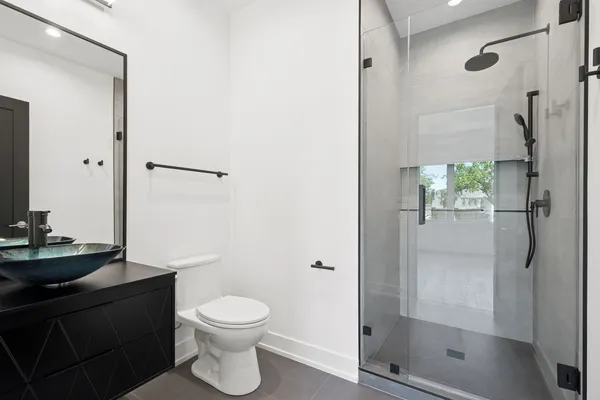 a bathroom with a toilet a sink and shower