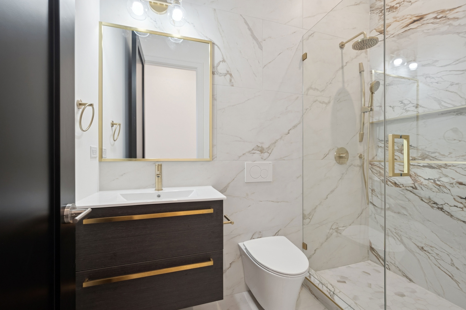 9214 Washington Street Niles, IL 60714 - Photo 20 of 33 a bathroom with a sink a toilet and shower