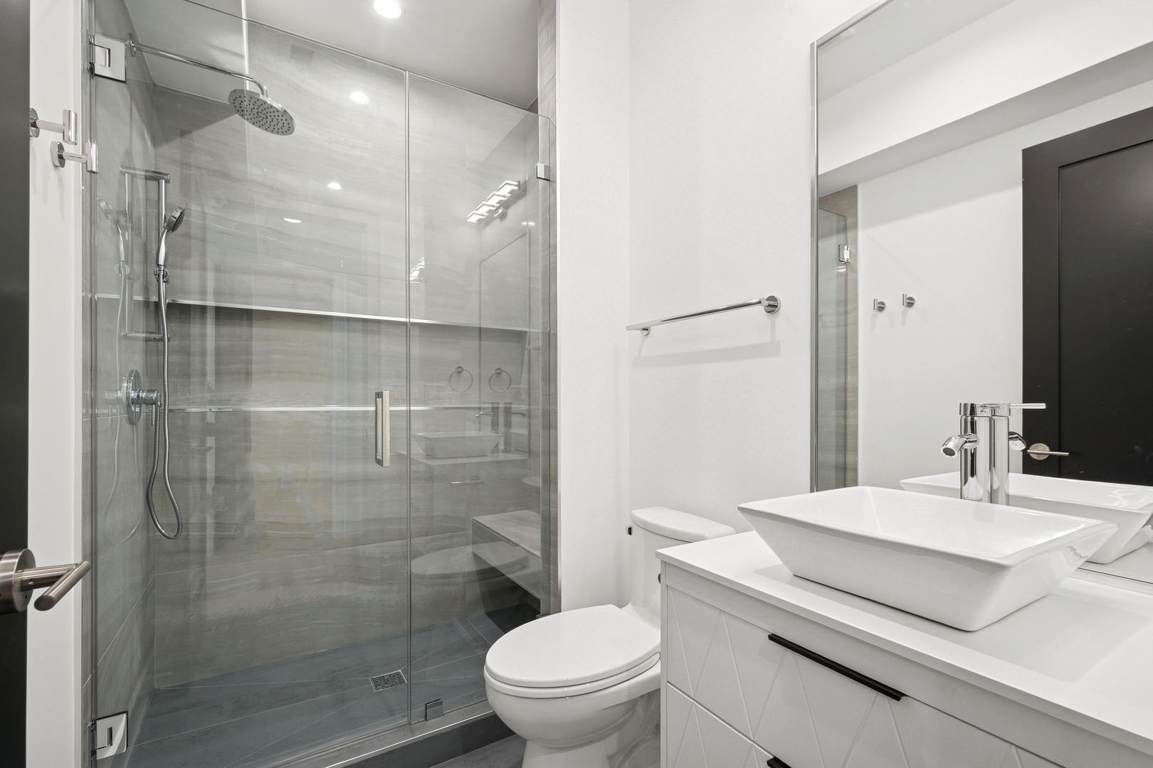 9214 Washington Street Niles, IL 60714 - Photo 21 of 33 a bathroom with a sink a toilet and shower