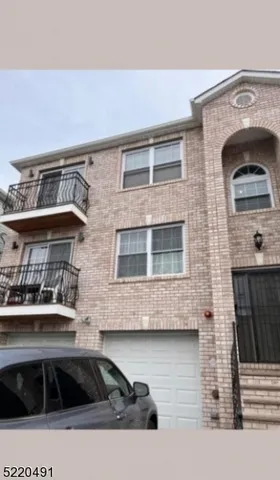 a front view of a building with parking space