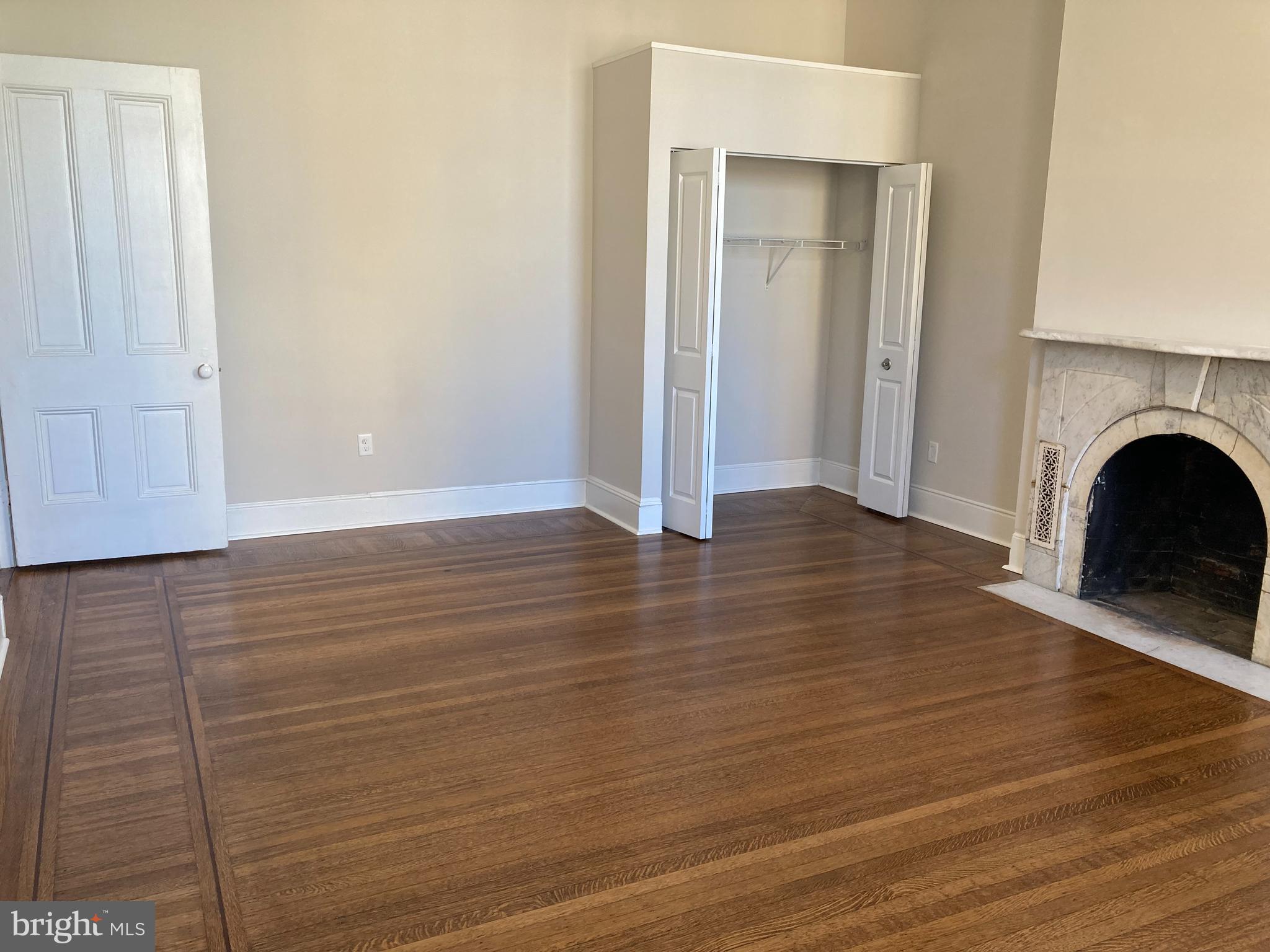 10 East Chase Street Baltimore, MD 21202 - Photo 24 of 60 a view of livingroom with hardwood floor and a fireplace