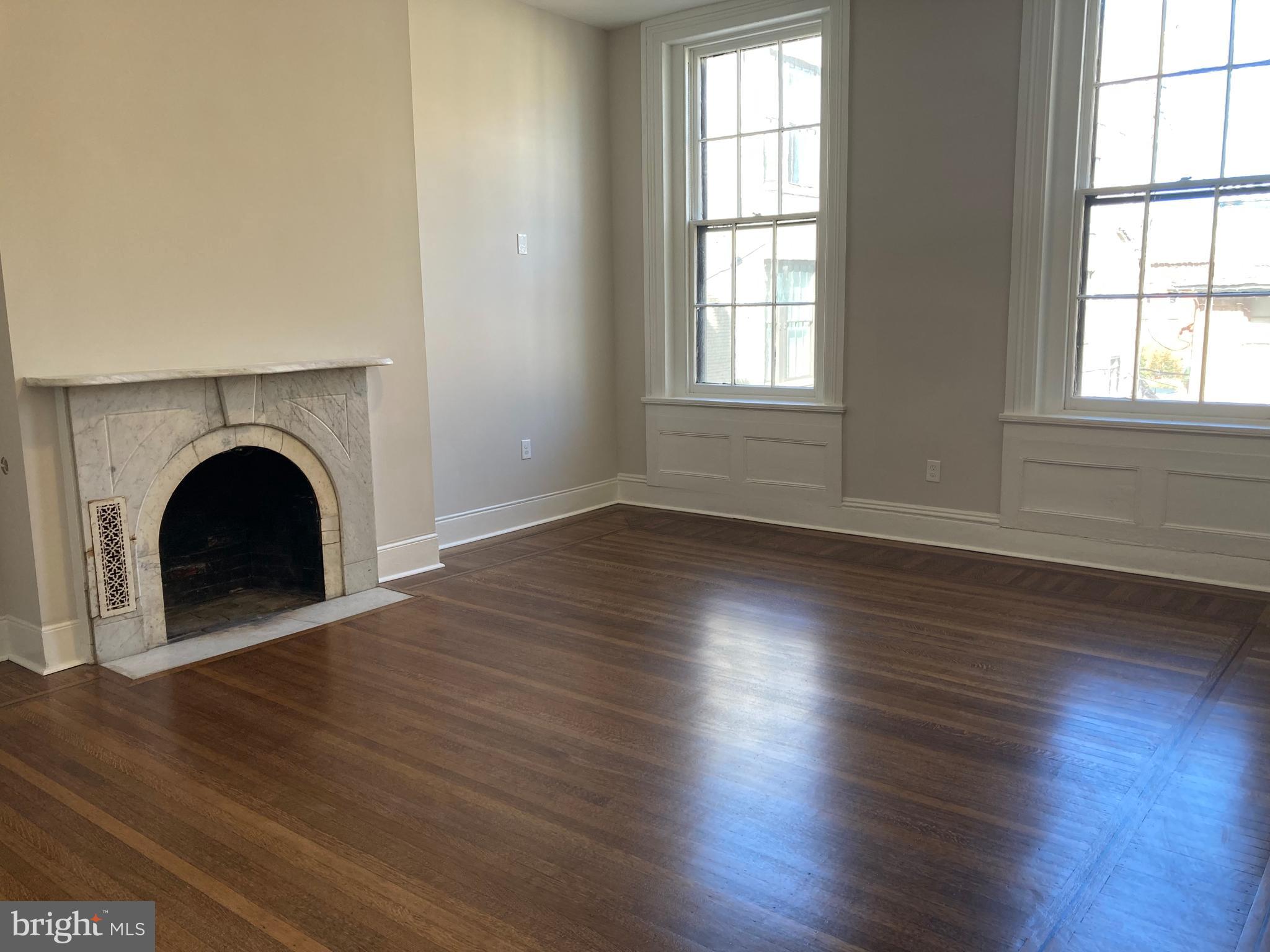 10 East Chase Street Baltimore, MD 21202 - Photo 27 of 60 an empty room with wooden floor and window