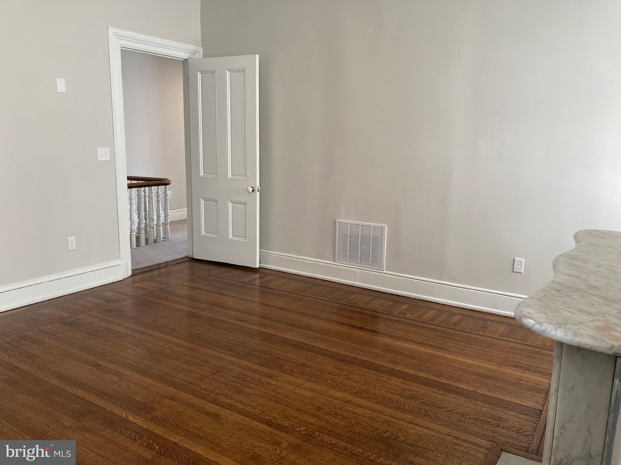 10 East Chase Street Baltimore, MD 21202 - Photo 29 of 60 a view of an empty room with wooden floor and a window
