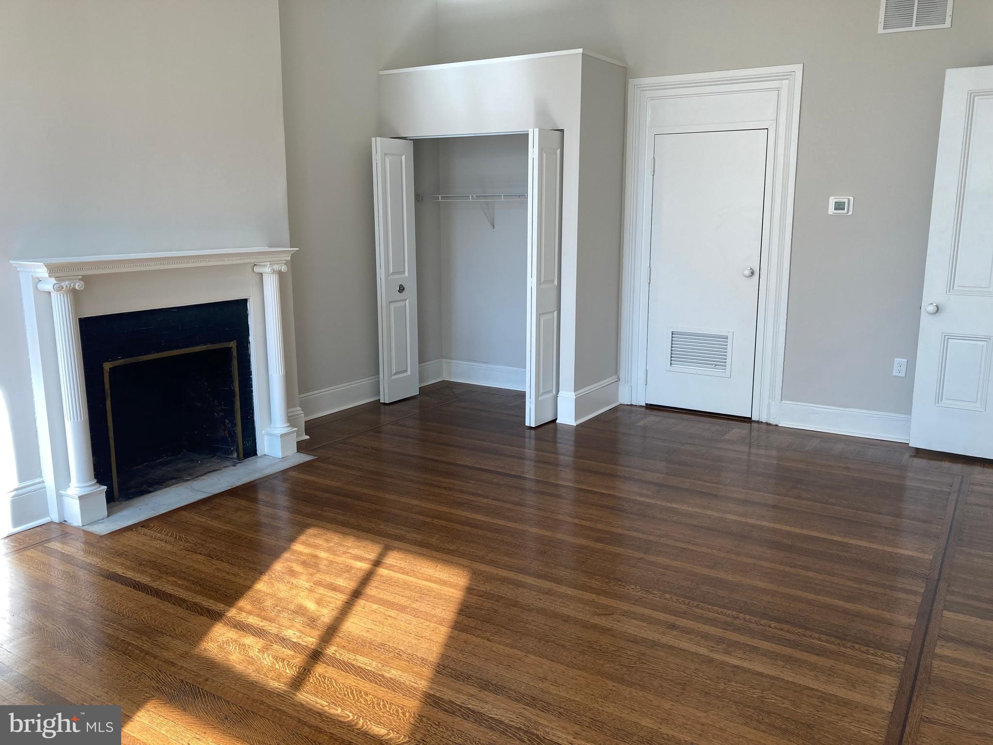 10 East Chase Street Baltimore, MD 21202 - Photo 34 of 60 wooden floor in an empty room with a fireplace