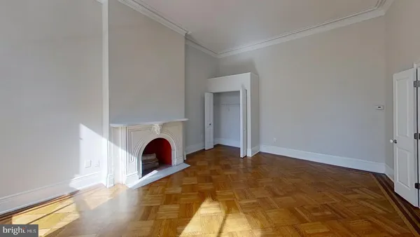 a view of a livingroom with a fireplace and window