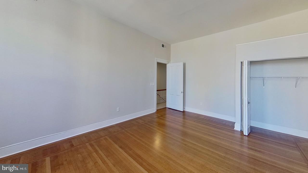 10 East Chase Street Baltimore, MD 21202 - Photo 47 of 60 a view of an empty room with wooden floor