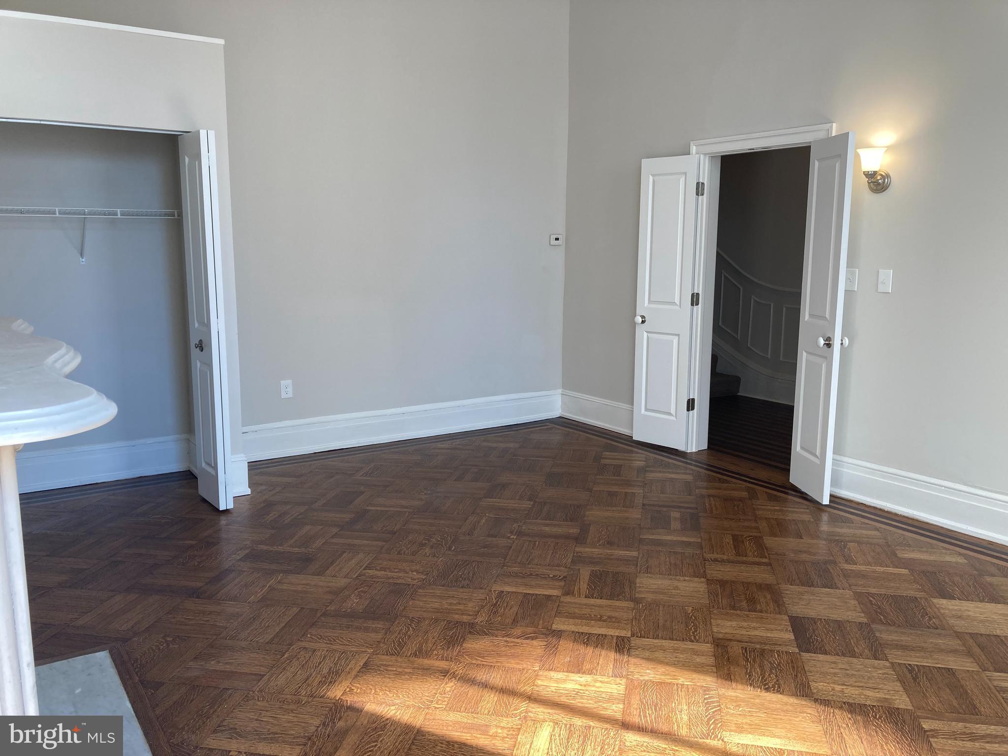 10 East Chase Street Baltimore, MD 21202 - Photo 5 of 60 a view of an empty room with wooden floor and a window