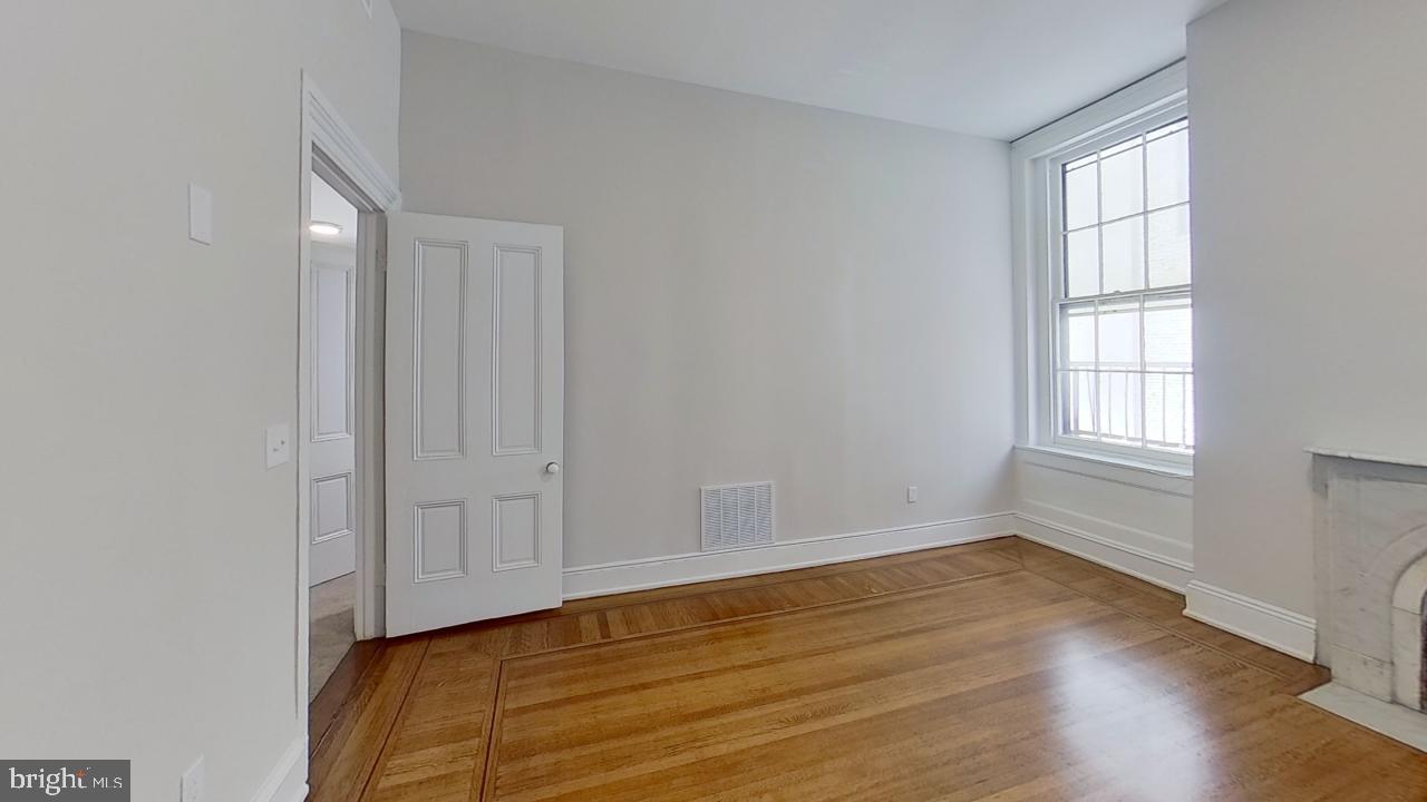10 East Chase Street Baltimore, MD 21202 - Photo 51 of 60 a view of an empty room with wooden floor and a window