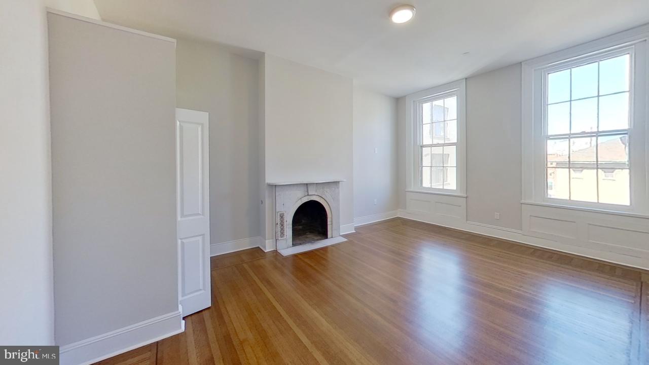 10 East Chase Street Baltimore, MD 21202 - Photo 53 of 60 a view of a livingroom with a fireplace and window