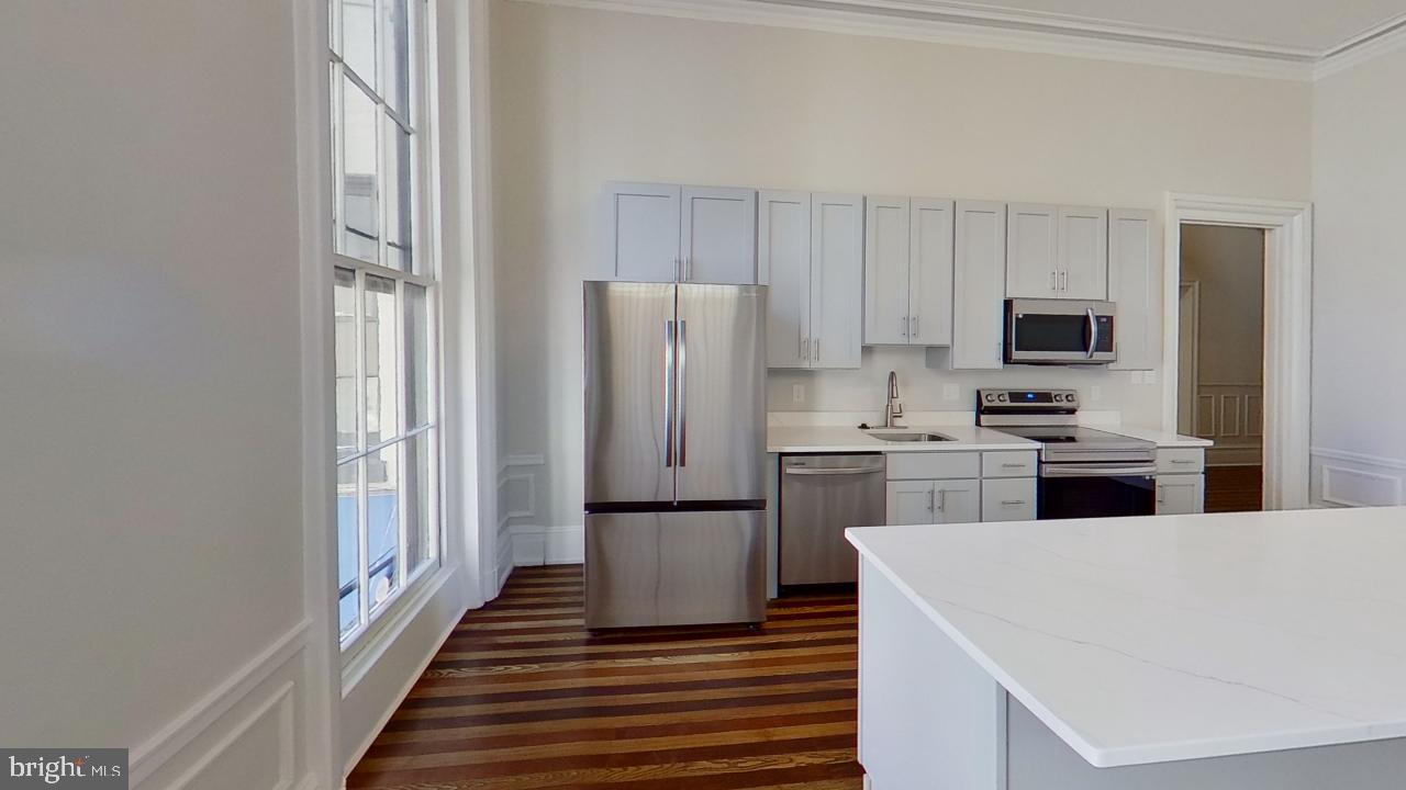 10 East Chase Street Baltimore, MD 21202 - Photo 55 of 60 a kitchen with cabinets and stainless steel appliances