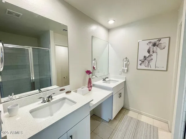 a bathroom with a double vanity sink mirror and double