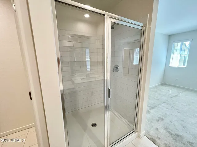 a bathroom with a glass shower door