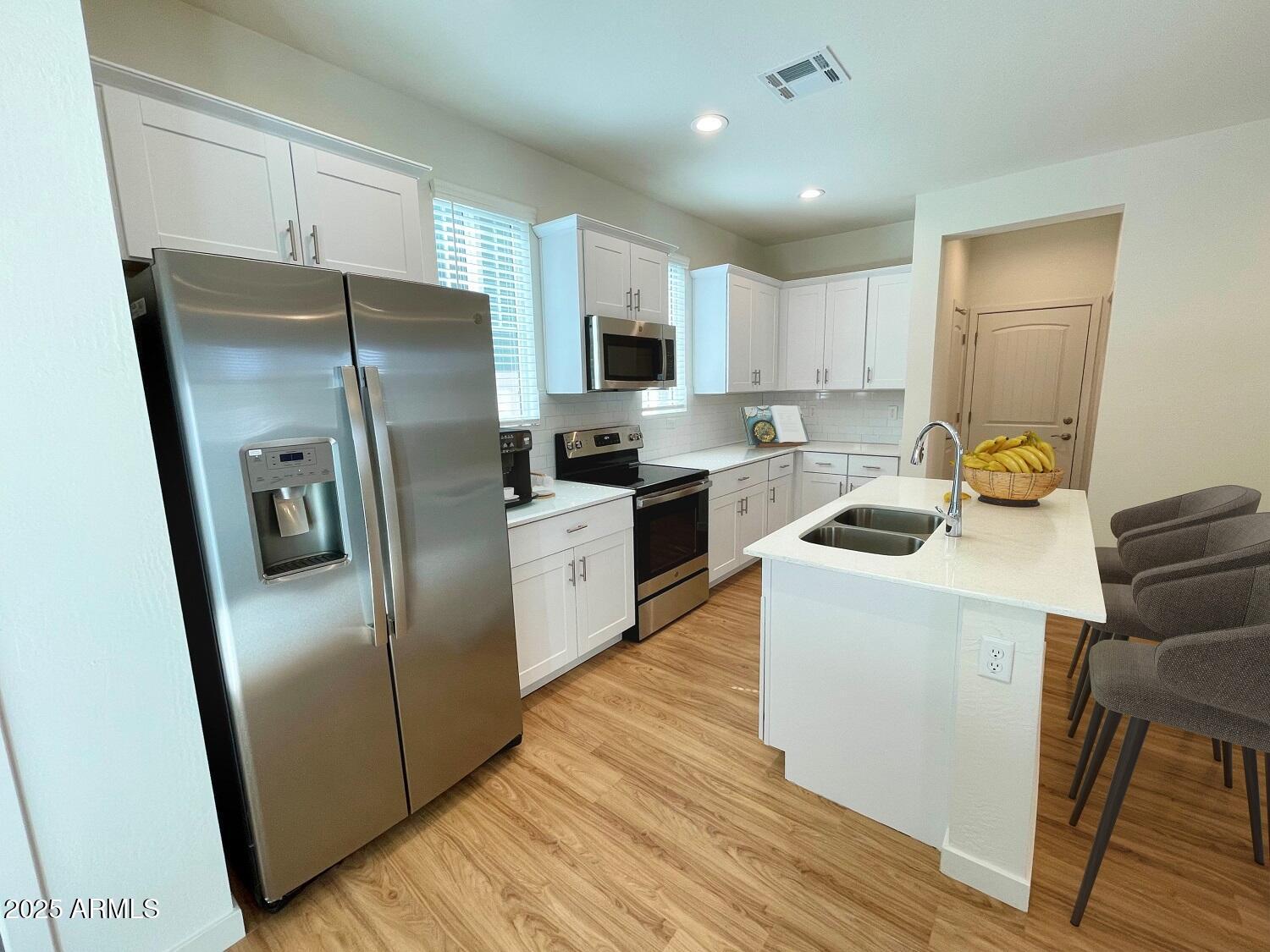 814 East Roma Avenue, Unit 2 Phoenix, AZ 85014 - Photo 6 of 20 a kitchen with a refrigerator a sink and cabinets