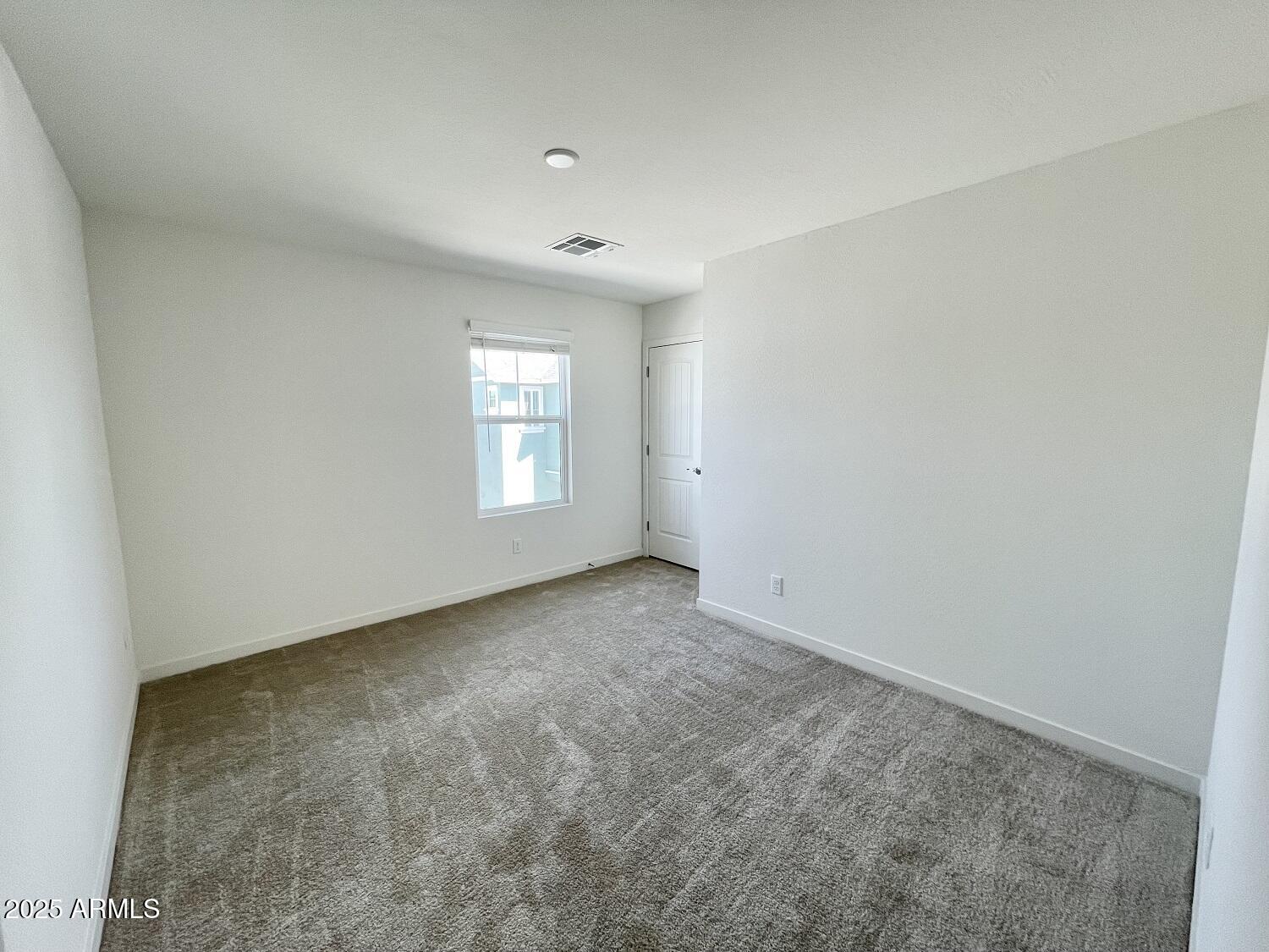 814 East Roma Avenue, Unit 2 Phoenix, AZ 85014 - Photo 9 of 20 an empty room with windows