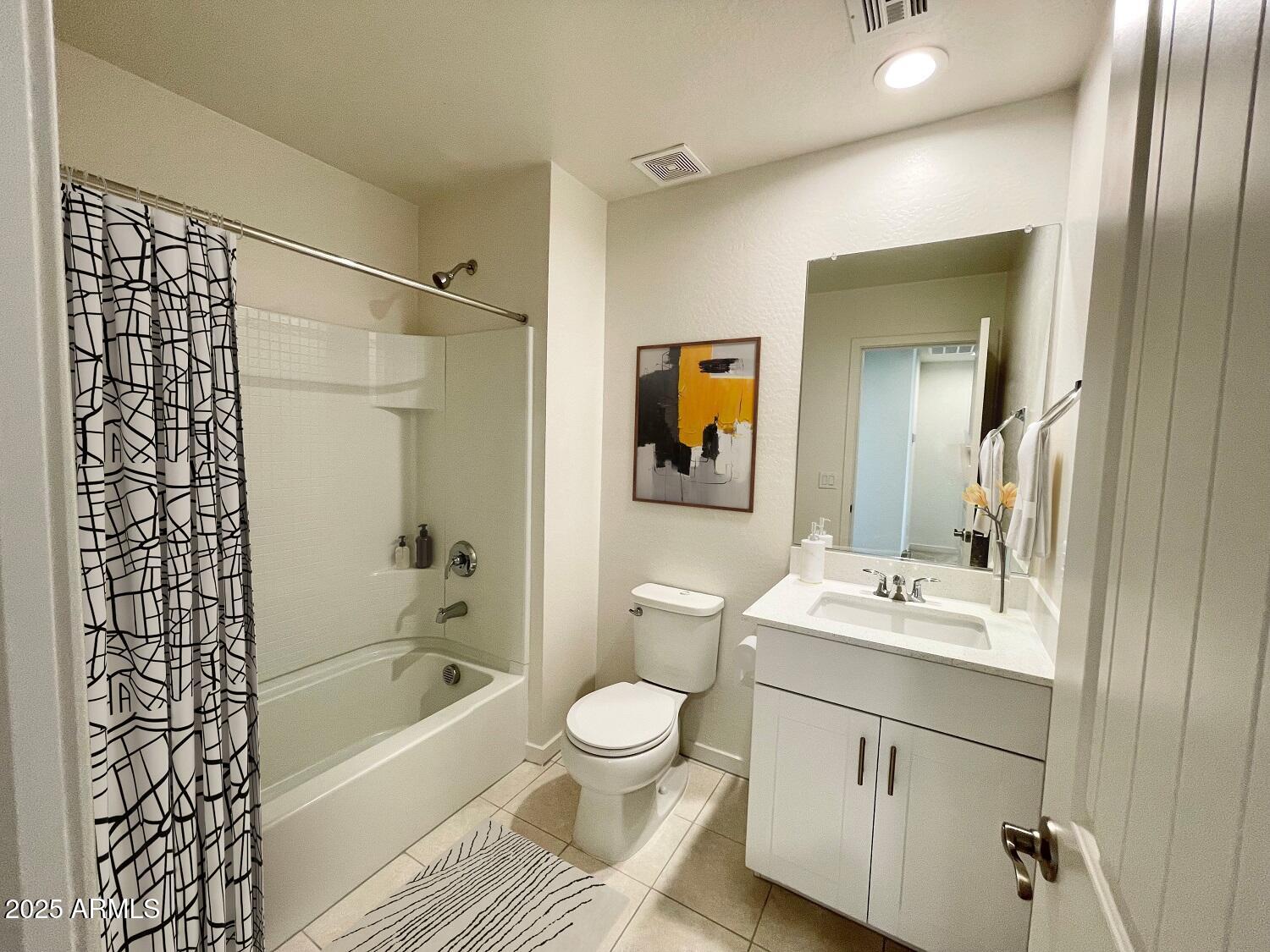 814 East Roma Avenue, Unit 2 Phoenix, AZ 85014 - Photo 10 of 20 a bathroom with a sink toilet a mirror a vanity and bathtub