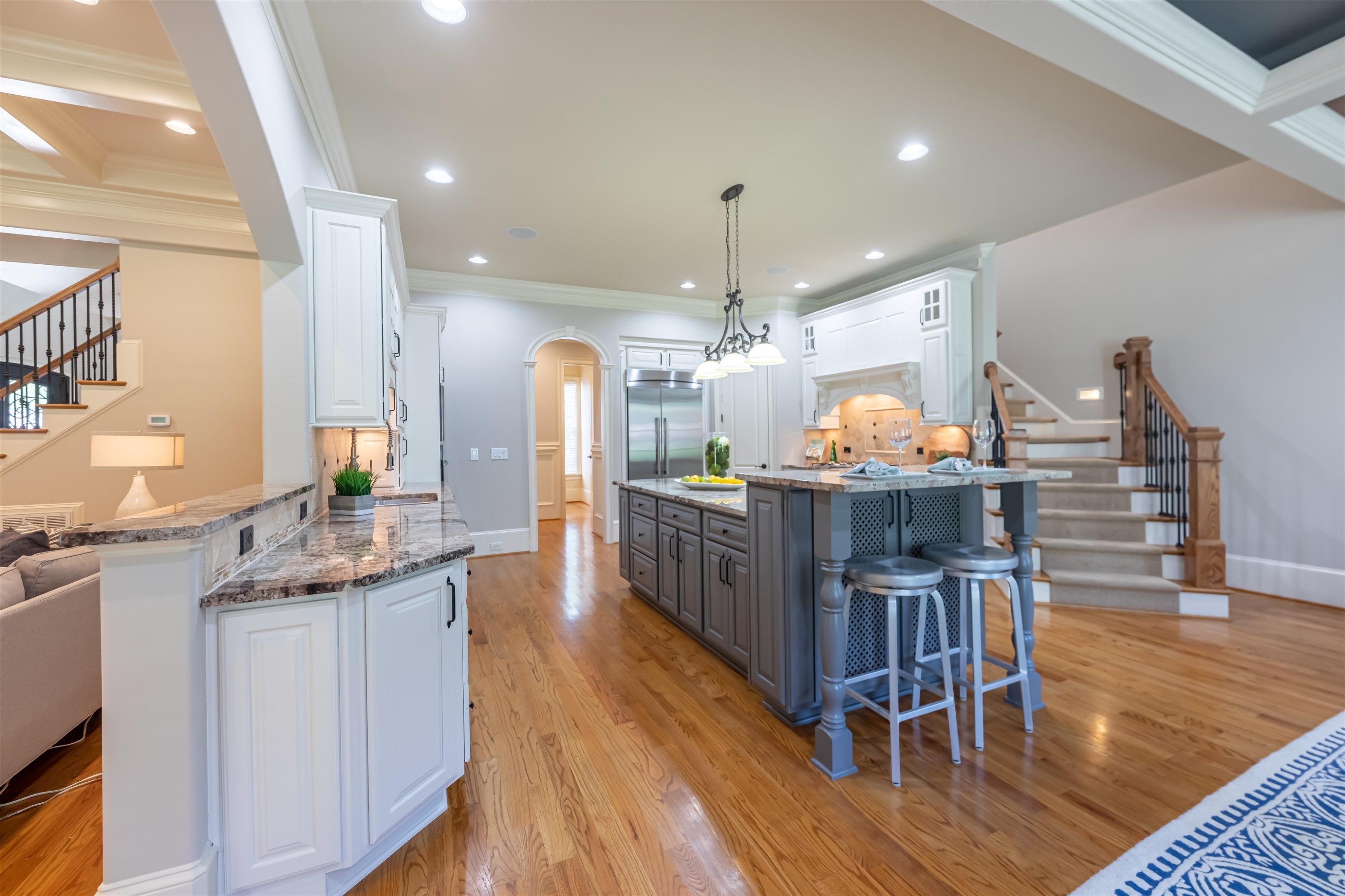 9805 Najma Street Raleigh, NC 27613 - Photo 13 of 30 There are granite counters, tile backsplash, under cabinet lights. The end of the island is raised with cabinets below. There is so much storage in this kitchen plus a walk in corner pantry. Kitchen Island