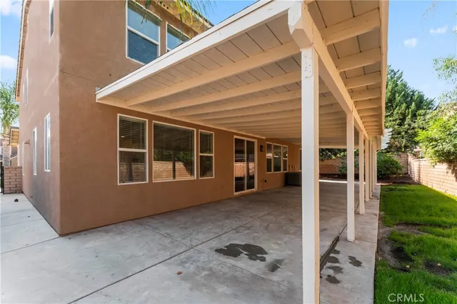 a view of house with backyard and glass windows