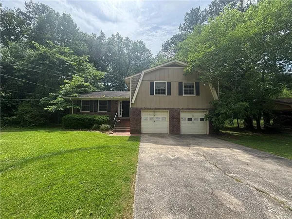 a front view of a house with a garden