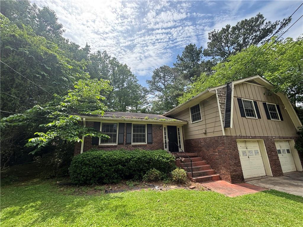4135 Moore Road Conley, GA 30288 - Photo 2 of 10 a front view of house with yard and green space