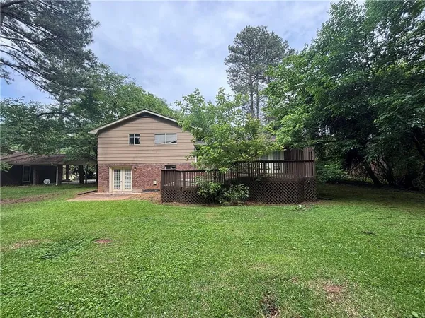 a view of a house with a yard and sitting area