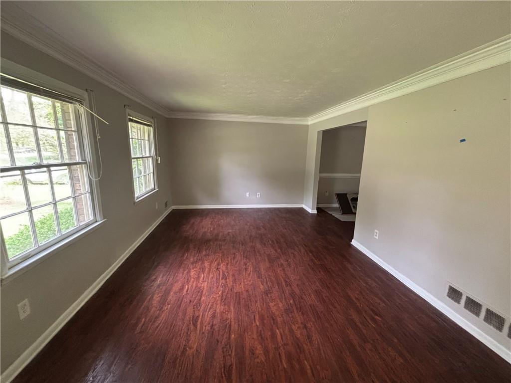 4135 Moore Road Conley, GA 30288 - Photo 8 of 10 an empty room with wooden floor and windows