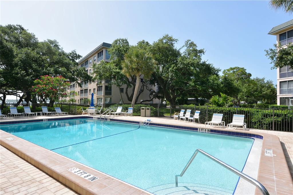 8625 Midnight Pass Road, Unit 305B Sarasota, FL 34242 - Photo 17 of 38 a view of a patio with swimming pool