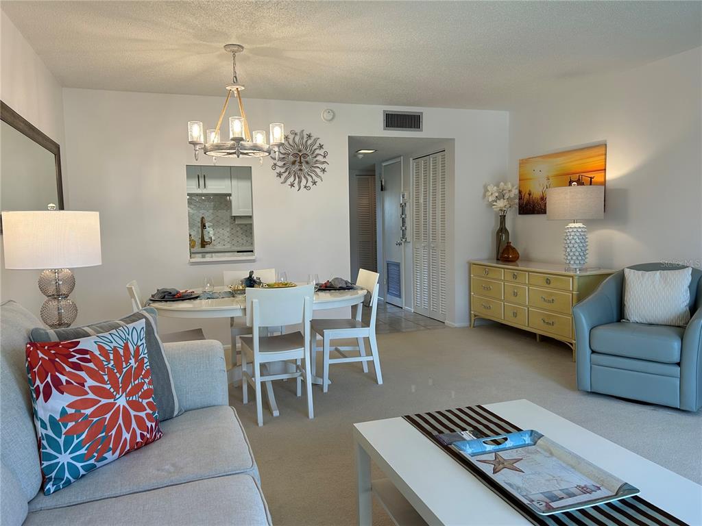 8625 Midnight Pass Road, Unit 305B Sarasota, FL 34242 - Photo 18 of 38 a living room with furniture and a chandelier