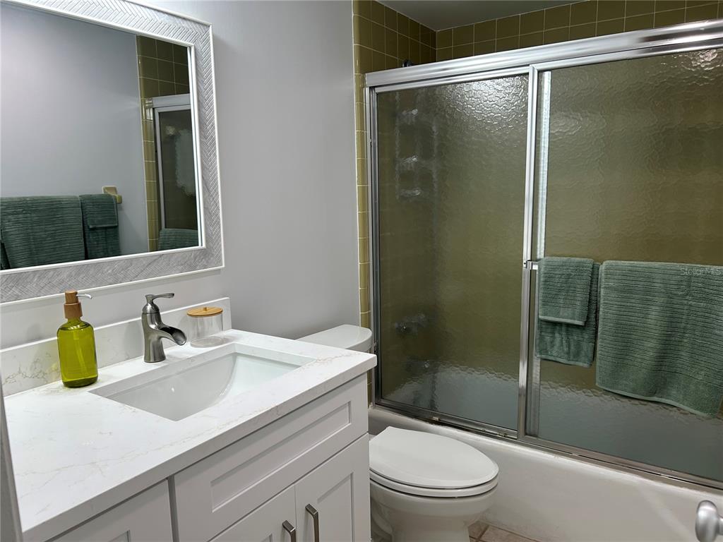 8625 Midnight Pass Road, Unit 305B Sarasota, FL 34242 - Photo 23 of 38 a bathroom with a sink toilet and shower