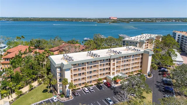 a living room with furniture a chandelier and a dining table