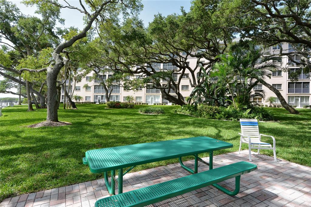 8625 Midnight Pass Road, Unit 305B Sarasota, FL 34242 - Photo 8 of 38 a view of a park with bench and trees