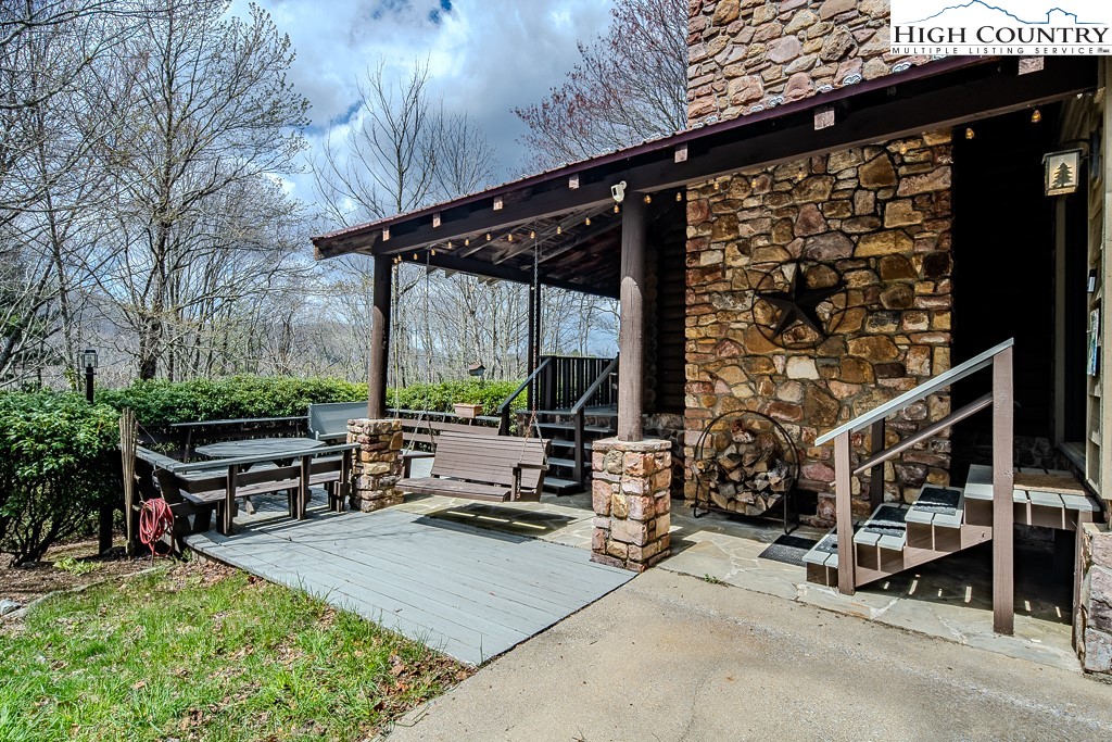 a view of a patio with table and chairs a barbeque with wooden fence